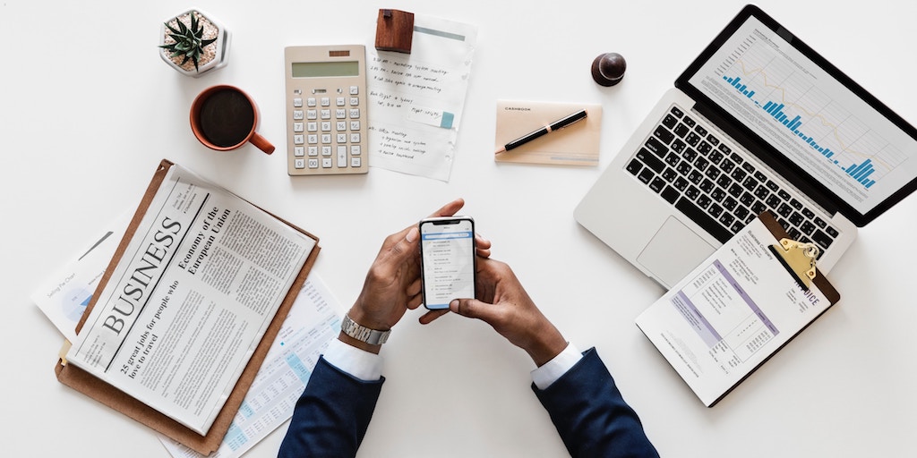 Person at desk holding a phone wonders about domain levels