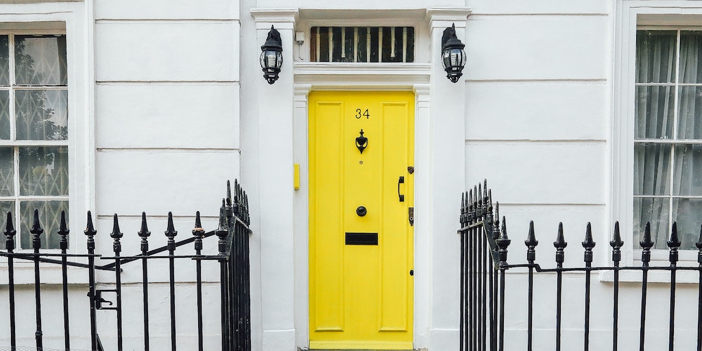 real estate domain name - a house with a bright yellow door
