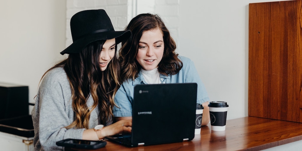 women typing on computer