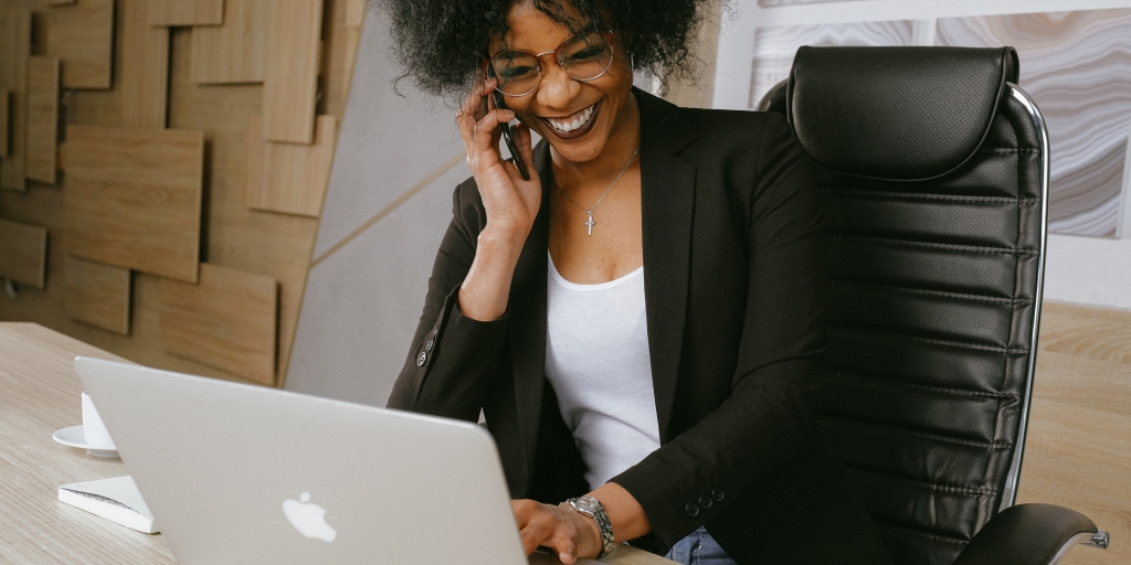 Happy woman bringing her business online with Hover