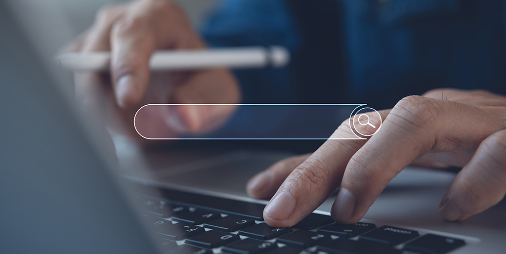 domain names matter - person at laptop searching for the best domain name